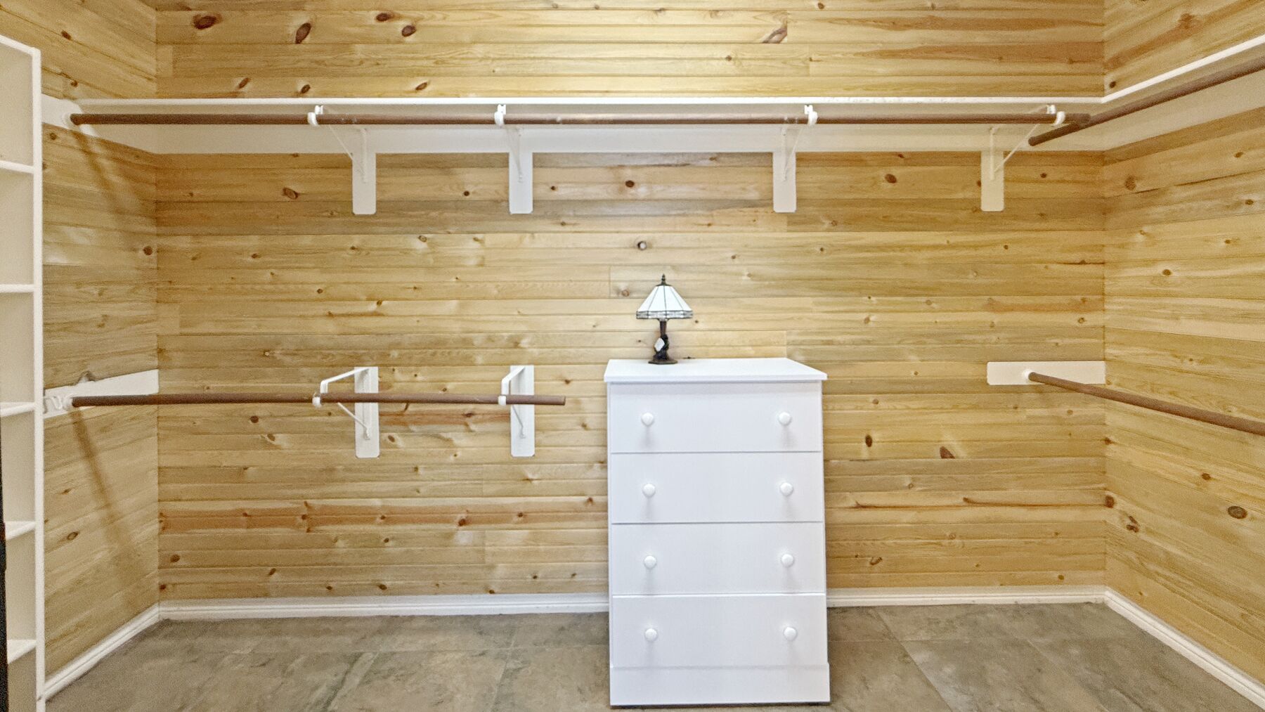 The primary walk-in closet at 2004 Athens Ave, lined in cedar plank with hanging rails and shelves on three walls